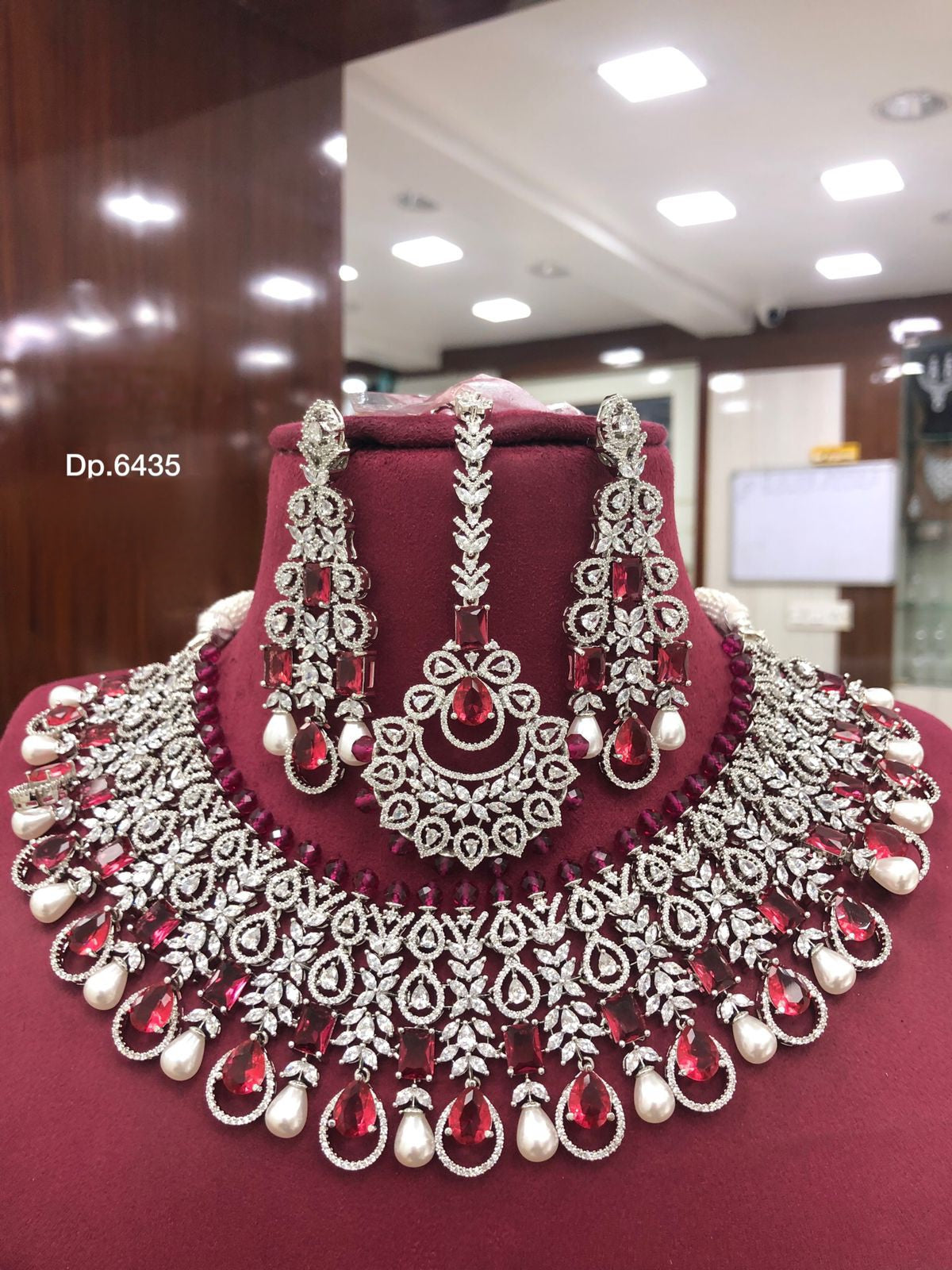 High Quality American diamond Full-bridal Necklace With Earrings and Maangtikka available in mint green / Red colour with Silver polished