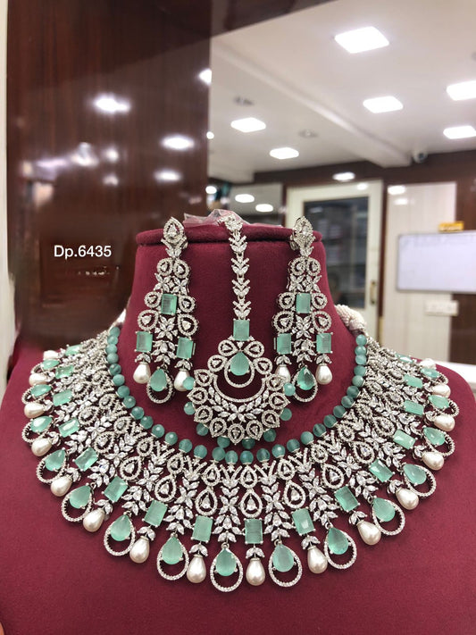 High Quality American diamond Full-bridal Necklace With Earrings and Maangtikka available in mint green / Red colour with Silver polished